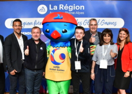 Group of people representing Virtus Global Games and La Region surround Lorri the Lorikeet mascot
